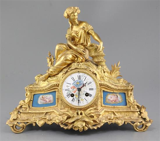 A Louis XV style gilt bronze 8 day mantel clock with Sevres style inset panels